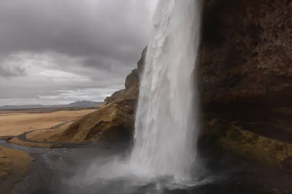 Walking behind Seljalandsfoss in Iceland.