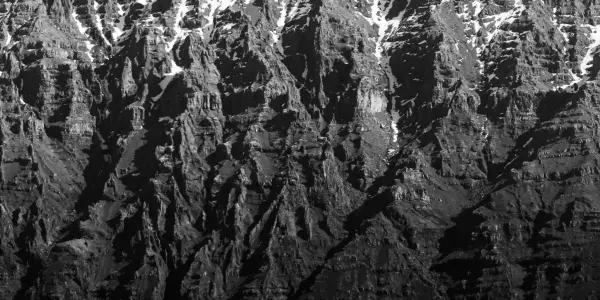 A mountain range zoomed in to reveal its deep groves.