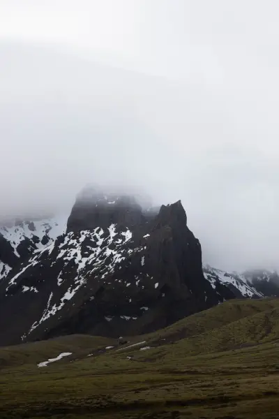 Large peak hidden by the clouds during a rainy day in Iceland.