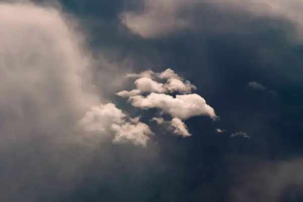 Clouds forming over Denver during a flight back from Iceland