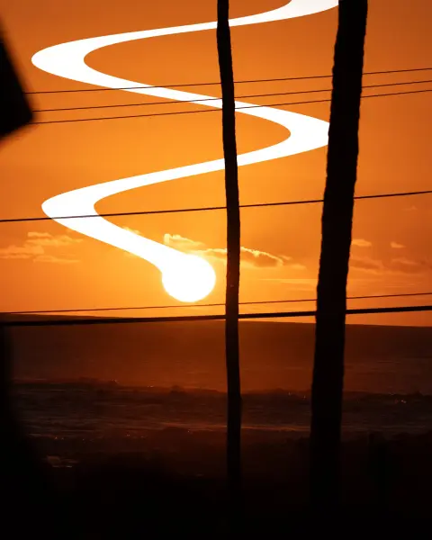 A manipulated pixel drag image using Photoshop, This one taken in Kauai. The sun weaving through the sky under the power lines.
