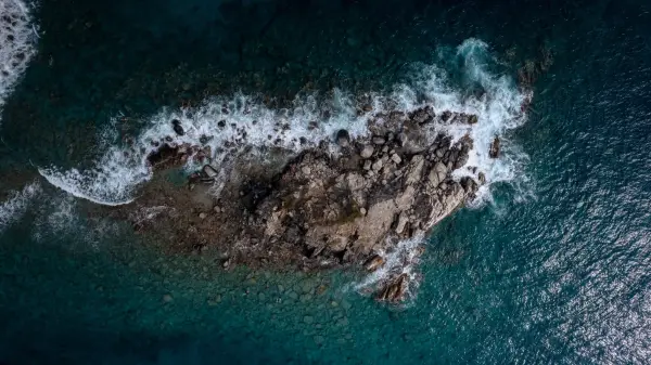 Above head view of a rocky island off cooper island, near cistern point, If you squint theres people in the water!