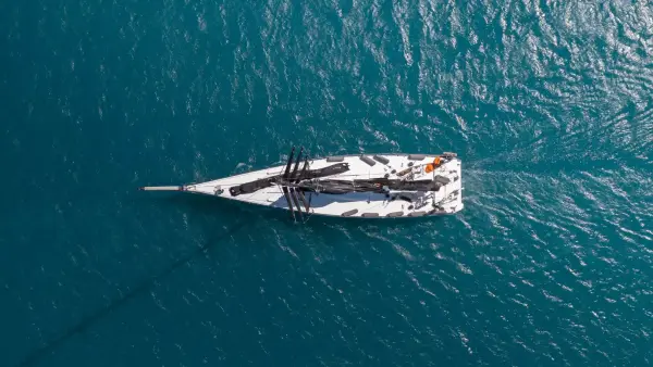 Sailboat packing its sails after the regatta.